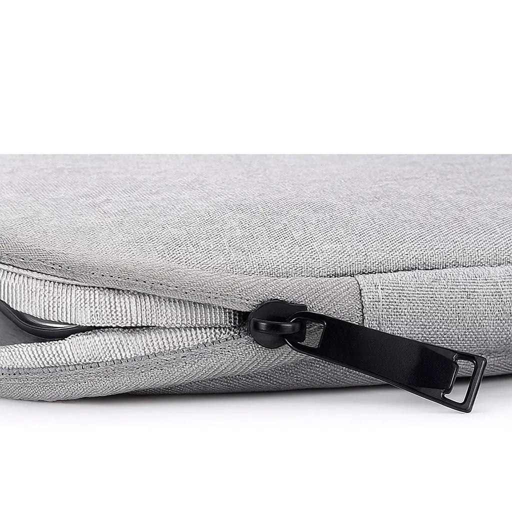 Gros plan sur la fermeture zippée renforcée de la housse ordinateur portable grise