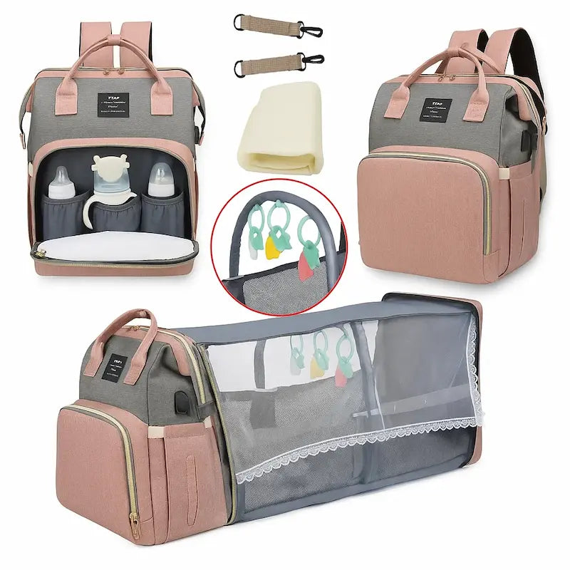 Sac à dos à langer bicolore gris et rose avec lit intégré déplié et compartiments visibles