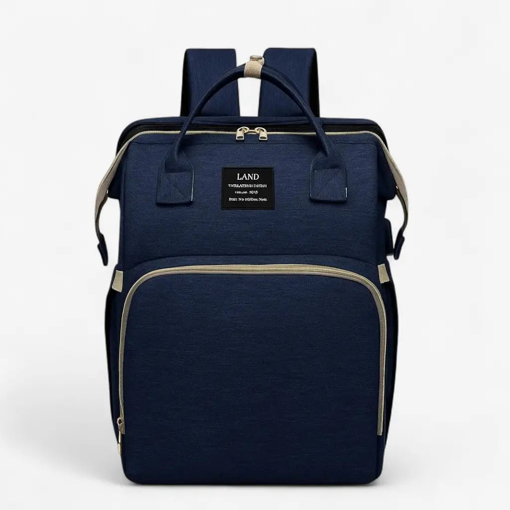 Sac à dos à langer bleu marine avec lit intégré, poche avant zippée fermée, vue de face