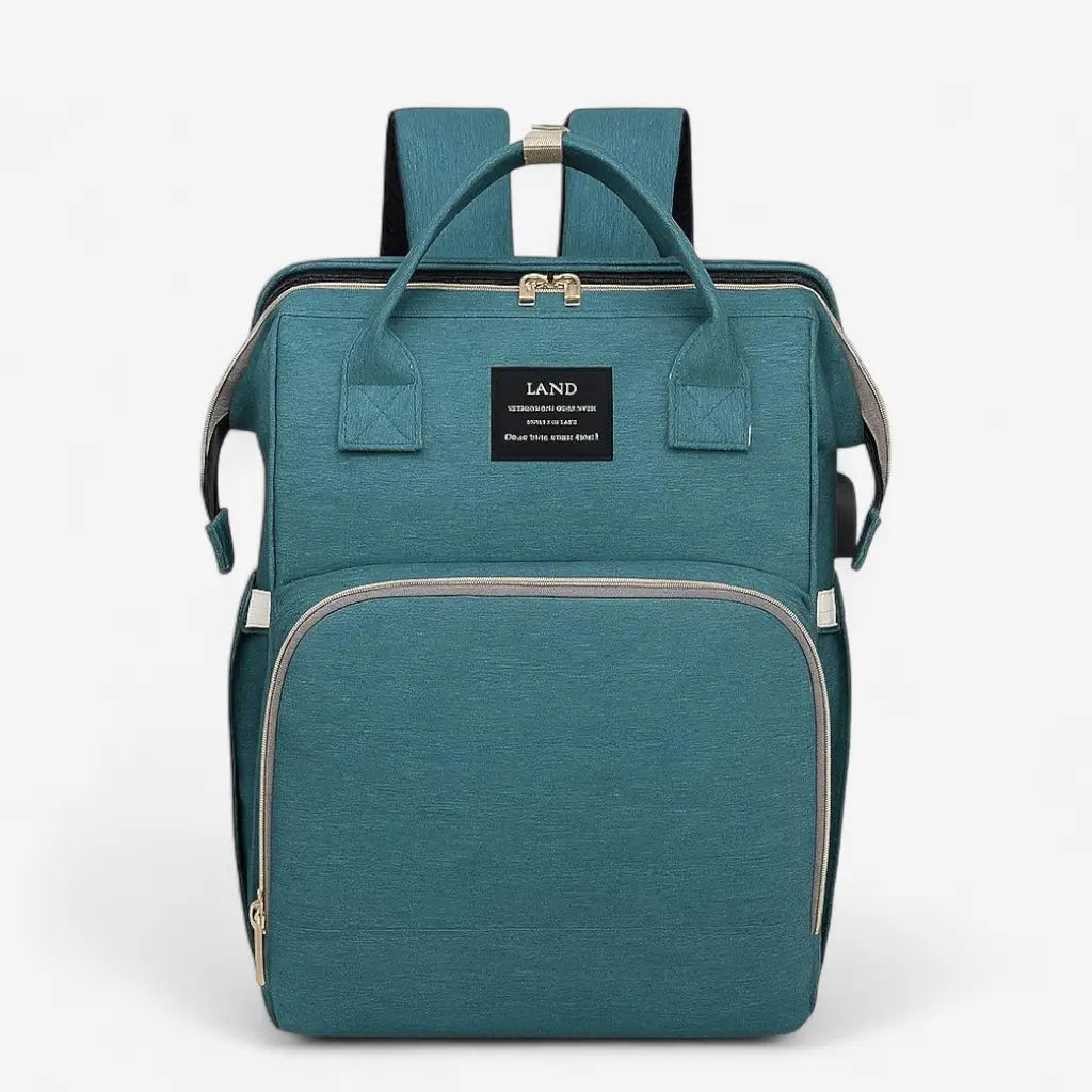 Sac à dos à langer vert avec lit intégré, poche avant zippée fermée, vue de face