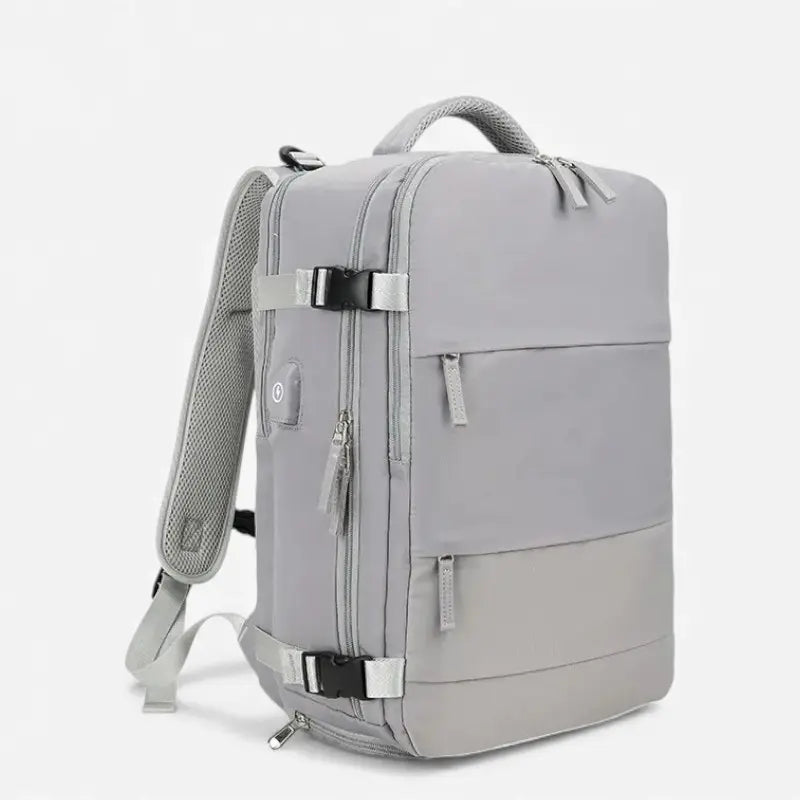 Vue latérale du sac à dos cabine avion gris au design minimaliste avec sangles de compression