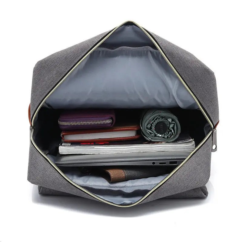 Intérieur du sac à dos gris unisexe avec ordinateur, livre et accessoires