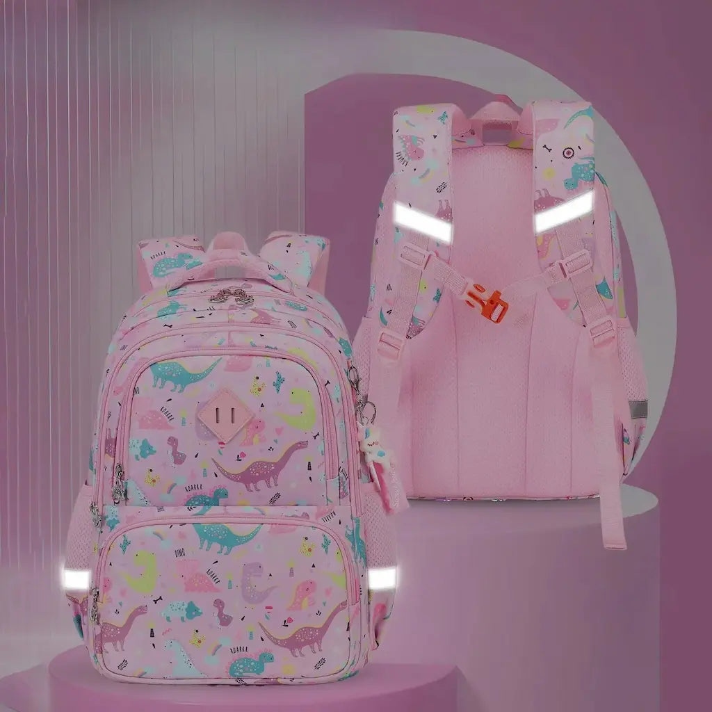 Sac à dos scolaire rose pour fille avec motifs dinosaures et bandes réfléchissantes pour la sécurité.