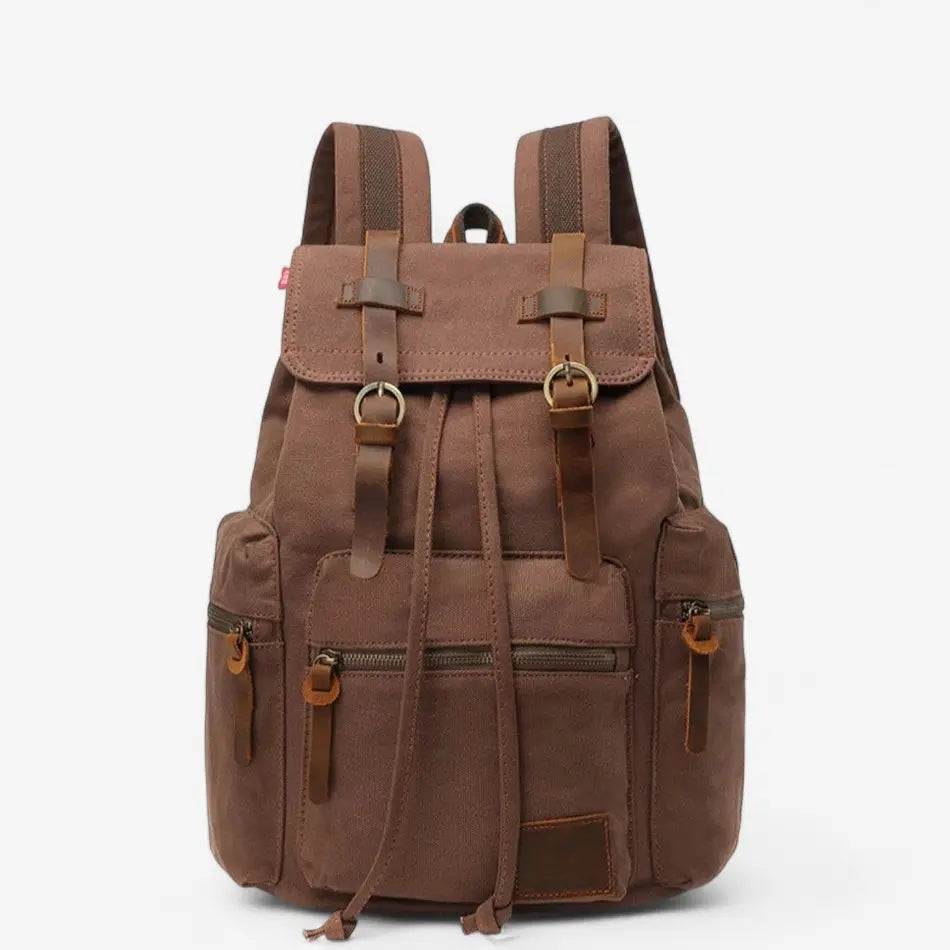 Sac à dos vintage en toile marron vu de face, sangles en cuir et poches avant.