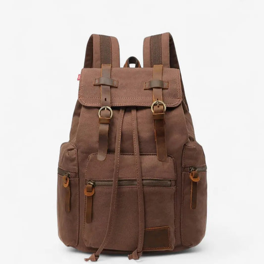 Sac à dos vintage en toile marron vu de face, sangles en cuir et poches avant.