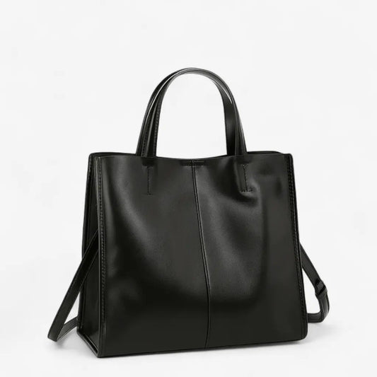 Sac à main noir en cuir de vachette, structure carrée avec double anse et bandoulière amovible.