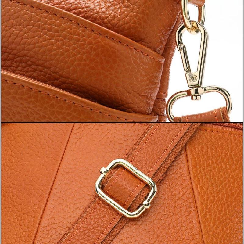 Détails des finitions et boucles métalliques du sac à bandoulière en cuir camel
