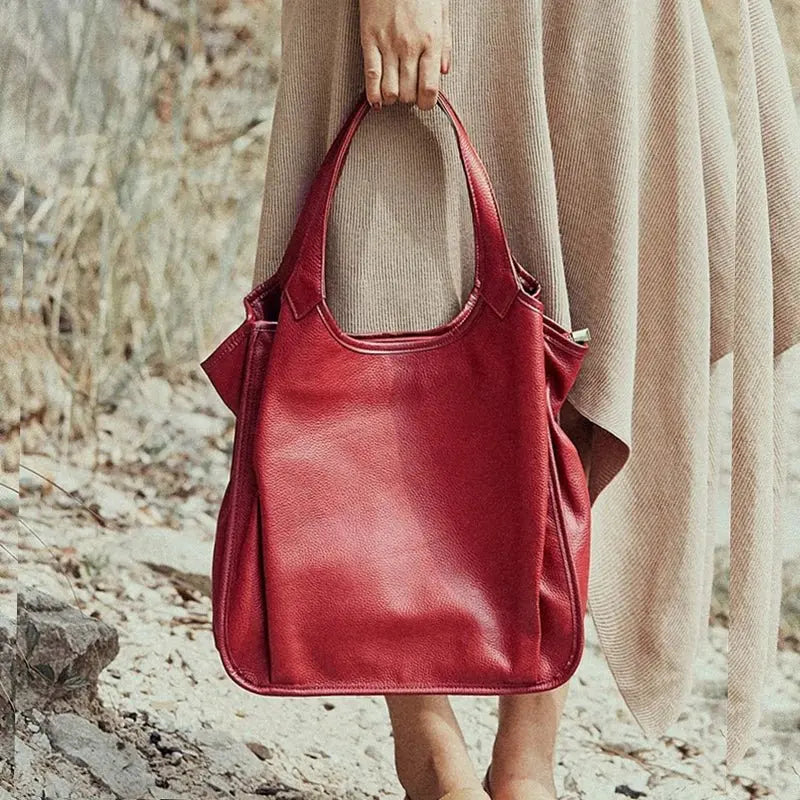 Femme tenant un sac cabas en cuir rouge élégant en situation quotidienne