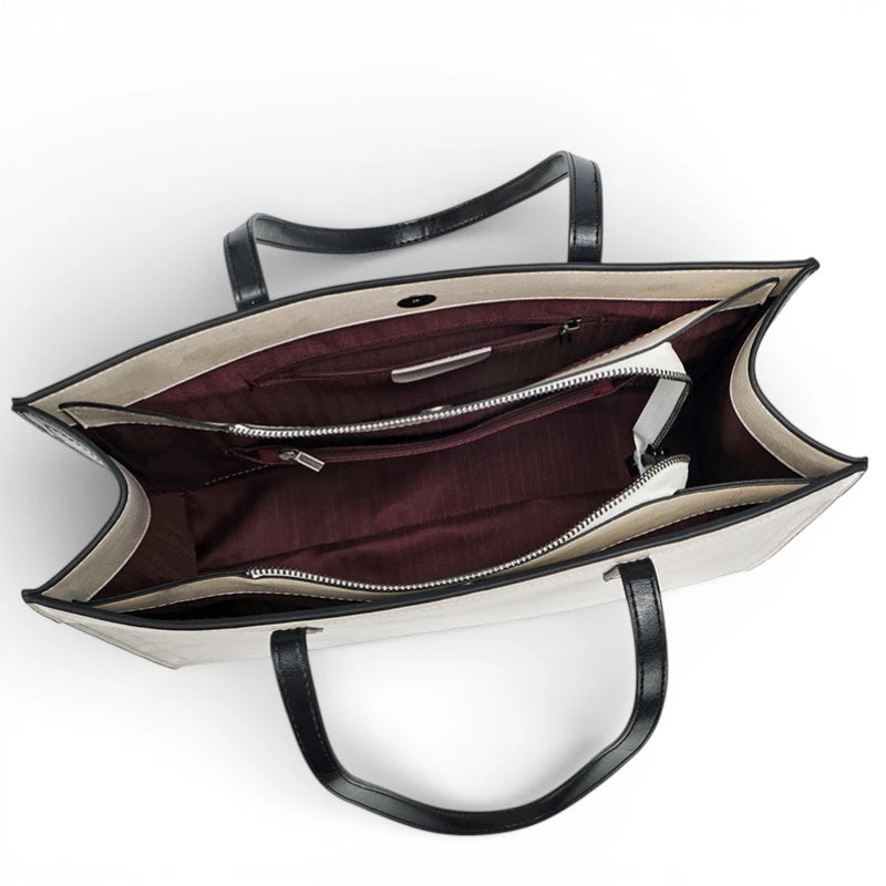 Intérieur du sac cabas femme en cuir de vachette avec compartiment central zippé et doublure bordeaux