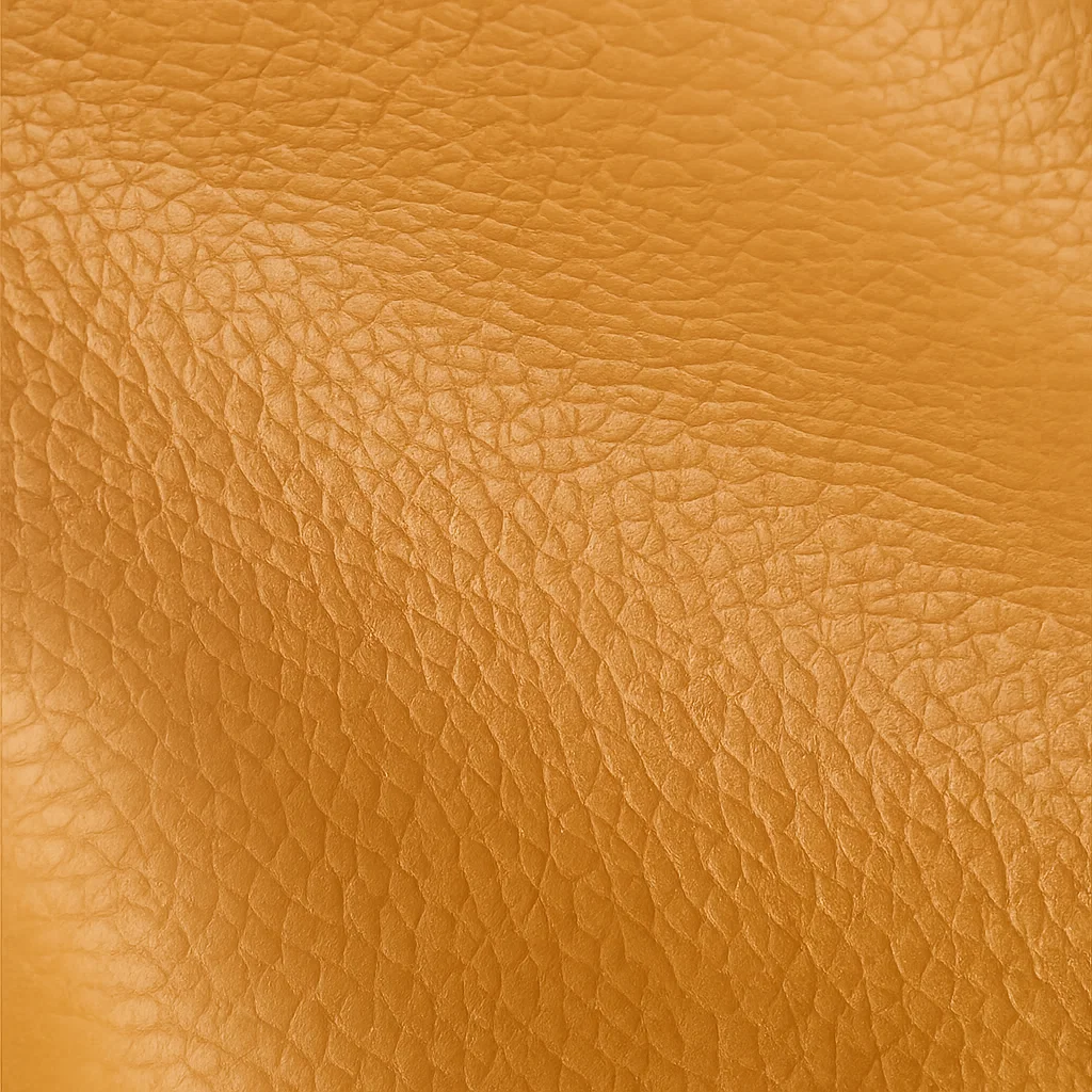 Gros plan détaillé sur la texture grainée du cuir camel du sac fourre-tout