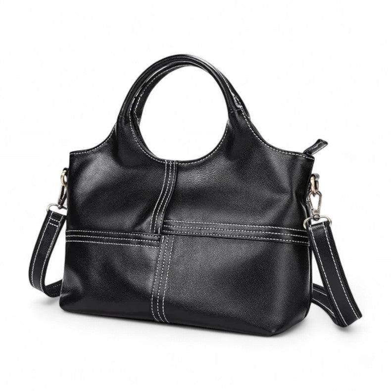 Vue avant du sac à main en cuir noir avec coutures apparentes et bandoulière amovible.