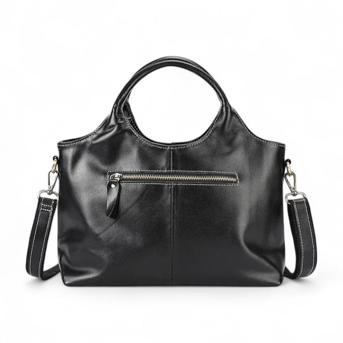 Vue arrière du sac à main en cuir noir avec poche zippée et finitions soignées.