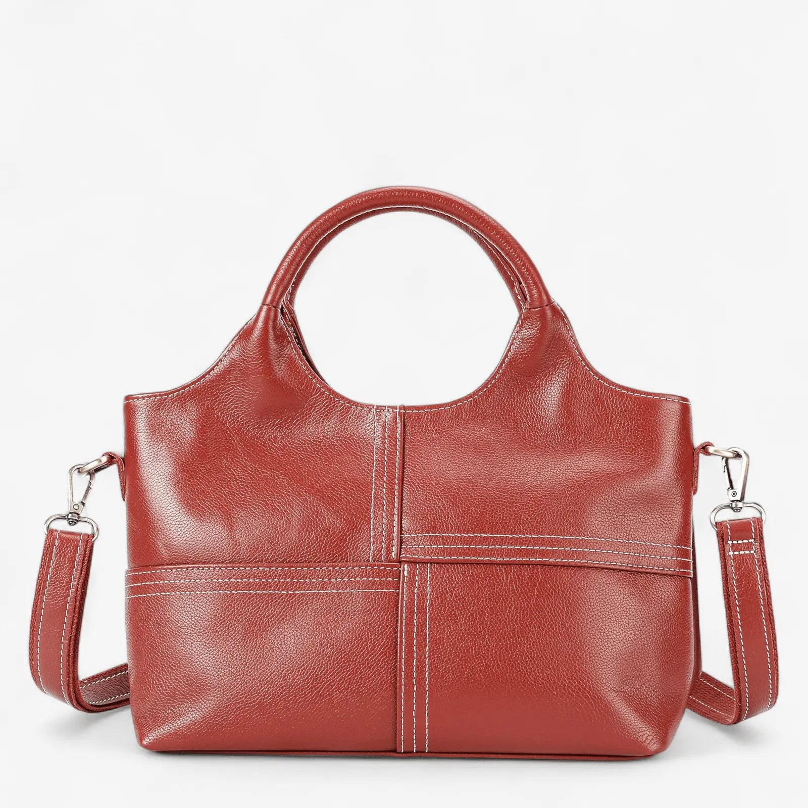 Sac à main en cuir de vachette rouge avec coutures apparentes et bandoulière amovible.