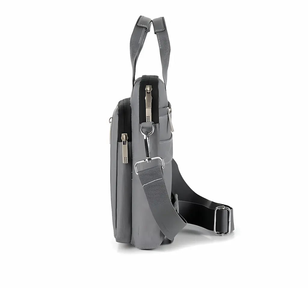 Vue de profil du sac pour ordinateur portable gris avec bandoulière