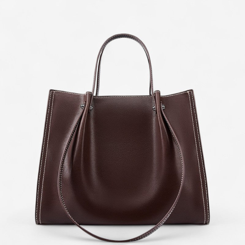 Sac porté épaule en cuir de vachette marron avec double anse arrondie et design structuré.