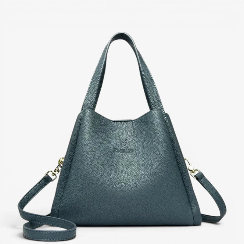 Sac seau bleu en cuir synthétique souple avec anses longues et bandoulière amovible
