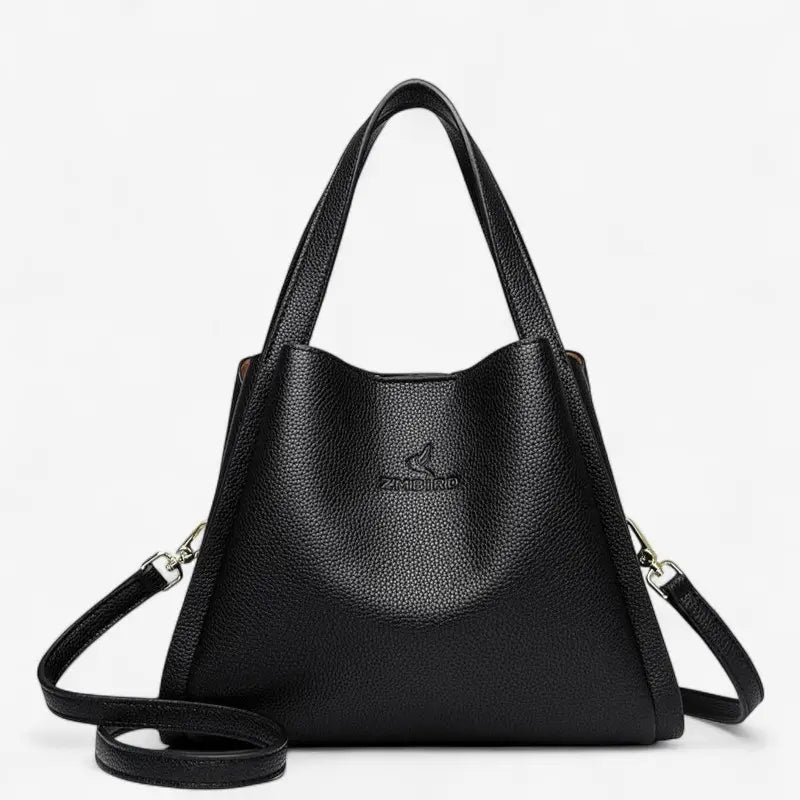 Sac seau noir en cuir synthétique souple avec bandoulière amovible et poignées renforcées