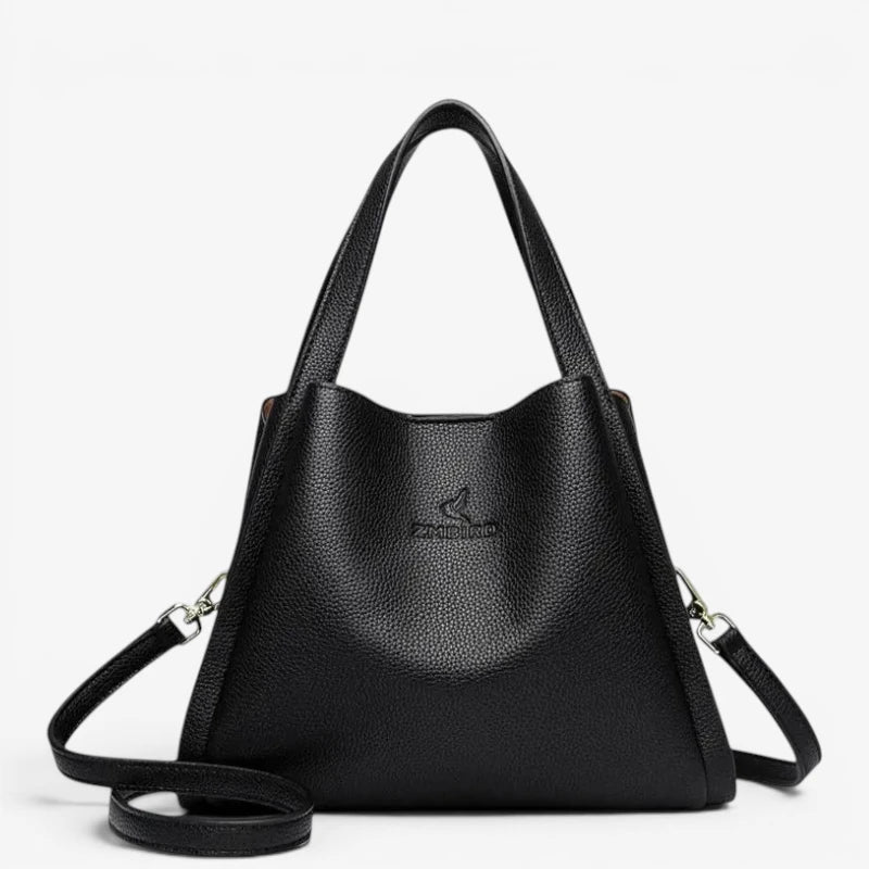 Sac seau noir en cuir synthétique souple avec bandoulière amovible et poignées renforcées