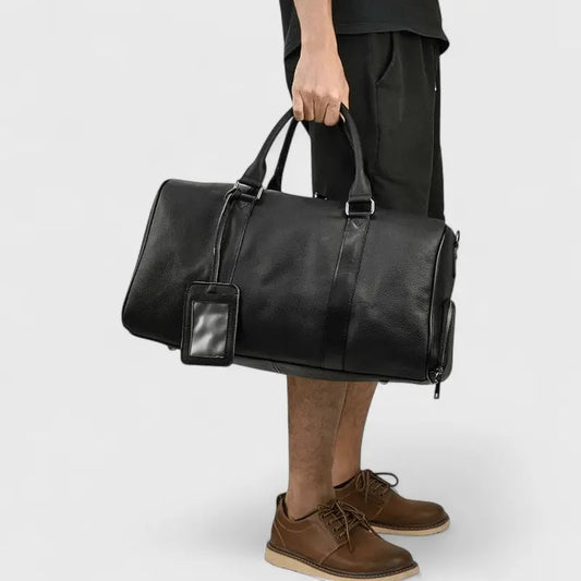 sac de voyage en cuir noir porté à la main – format week-end élégant